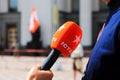 Kyiv, Ukraine, 28 06 2019. A man holds a red microphone with the logo of the popular Ukrainian TV channel ICTV