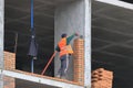 A bricklayer works at a construction site.