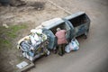 KYIV, UKRAINE MARCH 31, 2019: A homeless man looking for food in a garbage dumpster. Urban Poverty