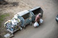 KYIV, UKRAINE MARCH 31, 2019: A homeless man looking for food in a garbage dumpster. Urban Poverty