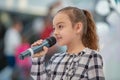 Kyiv, Ukraine March 03.2019. UKFW. Ukrainian Kids Fashion Day. Girl holds microphone in her hand while performing song at the Royalty Free Stock Photo