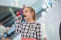 Kyiv, Ukraine March 03.2019. UKFW. Ukrainian Kids Fashion Day. Girl holds microphone in her hand while performing song at the Royalty Free Stock Photo