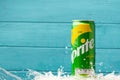 KYIV, UKRAINE - May 13: Close up shot of water splash over classic Sprite green can on the turquoise wooden background. Popular