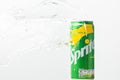 Close up shot of water splash over classic Sprite green can on the white background. Popular beverage Royalty Free Stock Photo