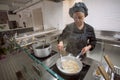 Cooking chef making italian food pasta or spaghetti at open kitchen inside modern restaurant Royalty Free Stock Photo