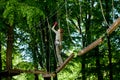 Kyiv, Ukraine- May 15, 2019 Girl in climbing gear on a rope park background . Rope park with obstacles and mountaineering. Extreme Royalty Free Stock Photo