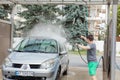 Kyiv, Ukraine- May 15, 2019 A man washes his car in a self-service sink in the summer outdoors