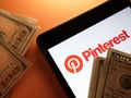 KYIV, UKRAINE - May 4, 2022 Pinterest logo and money for monetization.