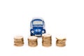 Focus of coins and blue toy car on white Royalty Free Stock Photo