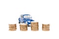 Focus of coins and blue toy car on white Royalty Free Stock Photo