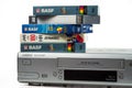 A stack of videotapes from leading manufacturers lies on the Phillips VCR