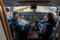 Kyiv, Ukraine - November 25, 2020: Embraer aircraft cockpit. Pilots in medical masks. Technicians diagnose, repair and service the