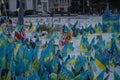 relatives set up many Ukrainian flags and lit candles to honor those who died in the war. place of memory