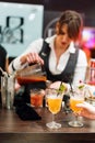 Kyiv, Ukraine - 30 october, 2016: Barman festival. Young pretty woman bartender is making cocktail.