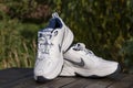 Beautiful new Nike Air Force white mens sneakers on wooden table, close up
