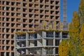 A group of high-rise assemblers work on the top floor of a construction site.