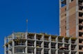 A group of high-rise assemblers work on the top floor of a construction site.