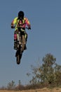 Jump on a motorcycle against the blue sky during a workout. Royalty Free Stock Photo