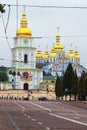 Picturesque cityscape of Kyiv. Wide cobbled road to the Mykhailivska Square with St. Michael`s Golden-Domed Monastery