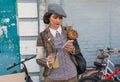 Beautiful young women in vintage clothing with mobile phone and retro bicycle ready for cycling