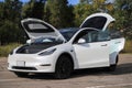 Car Tesla Model Y with open doors