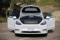 Car Tesla Model Y with open doors