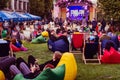 Kyiv, Ukraine - September 22, 2019. Comic Con. People sitting on colorful bean bag chairs, relaxing and chating outdoors