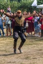 A Georgian man from a group of ethnic dancers from the country of Georgia perform in the open air.