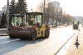 KYIV, UKRAINE - September 10, 2020: Heavy asphalt road roller with heavy vibration roller compactor that press new hot Royalty Free Stock Photo