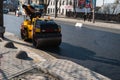KYIV, UKRAINE - September 10, 2020: Heavy asphalt road roller with heavy vibration roller compactor that press new hot Royalty Free Stock Photo