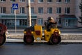 KYIV, UKRAINE - September 10, 2020: Heavy asphalt road roller with heavy vibration roller compactor that press new hot Royalty Free Stock Photo