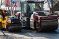 KYIV, UKRAINE - September 10, 2020: Heavy asphalt road roller with heavy vibration roller compactor that press new hot Royalty Free Stock Photo