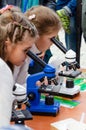 Kyiv, Ukraine - September 28, 2019. Shevchenko park. Science Picnics. Two curious little girls look through microscopes