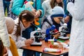 Kyiv, Ukraine - September 28, 2019. Shevchenko park. Science Picnics. Two curious little kids look through microscopes