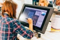 KYIV, UKRAINE - SEPTEMBER 22, 2018: Young woman draws with Wacom tablet