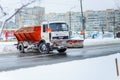 Kyiv, Ukraine-25.12.17: Snow plow clears roads in the city after heavy winter snowfall blizzard for vehicle access. Big orange car