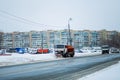 Kyiv, Ukraine-25.12.17: Snow plow clears roads in the city after heavy winter snowfall blizzard for vehicle access. Big orange car