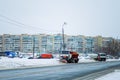 Kyiv, Ukraine-25.12.17: Snow plow clears roads in the city after heavy winter snowfall blizzard for vehicle access. Big orange car