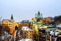 Kyiv, Ukraine. View of Andrew`s descent in winter during the cloudy moody day. Snow over the mountain, famous St Andrew church in