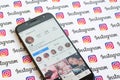 Kylie Jenner official instagram account on smartphone screen on paper instagram banner