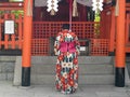 KYOTO, JAPAN - APRIL, 16, 2018: female japanese worshiper bowing at fushimi inari shrine