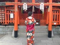 KYOTO, JAPAN - APRIL, 16, 2018: female japanese worshiper at fushimi inari shrine