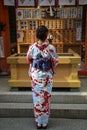 KYOTO, JAPAN- APRIL 03, 2019: Japanese girl in kimono dress in front of Jinja-Jishu shrine at the famous Kiyomizu-dera Buddhist Royalty Free Stock Photo