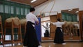 Kyudo practicing bow shooting in Kyoto, Japan. Archery shoot in slowmotion.