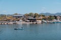 Tourists rowing boat in Katsura River in Arashiyama district with cherry blossom in spring time