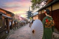 Scenic cityscape of Yasaka pagoda in Kyoto with a young Japanese woman in a traditional Kimono dress in full bloom cherry blossom Royalty Free Stock Photo