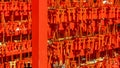 Many small red torii gates with prayers left by devotees at famous Fushimi Inari-Taisha Shinto Shrine in Kyoto, Japan,