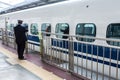 Kyoto, Japan - December 30, 2009: Stationmaster standing near N700 shinkansen bullet train departing Kyoto station Royalty Free Stock Photo