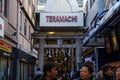 People and tourists walking on Teramachi commercial street entrance, signs Royalty Free Stock Photo