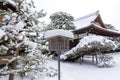 Snowy traditional Japanese building in Kinkaku-ji garden. Snow landscape.